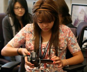 Yetzabell Rojas studies her handheld camcorder during videography class in Phoenix, Friday June 3, 2011. (SJI Photo/Rachel Jimenez)